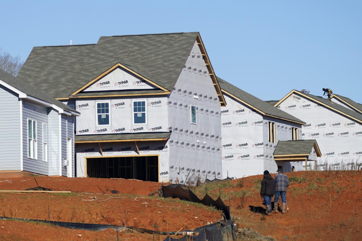 New homes are seen under construction in Mebane, N.C., Monday, Jan. 10, 2022.  Construction of new homes in the U.S. rose again in December as builders ramp up projects amid a persistent shortage of homes. The December increase left home construction at a seasonally adjusted annual rate of 1.70 million units, the Commerce Department reported Wednesday, Jan. 19, the third straight monthly gain.