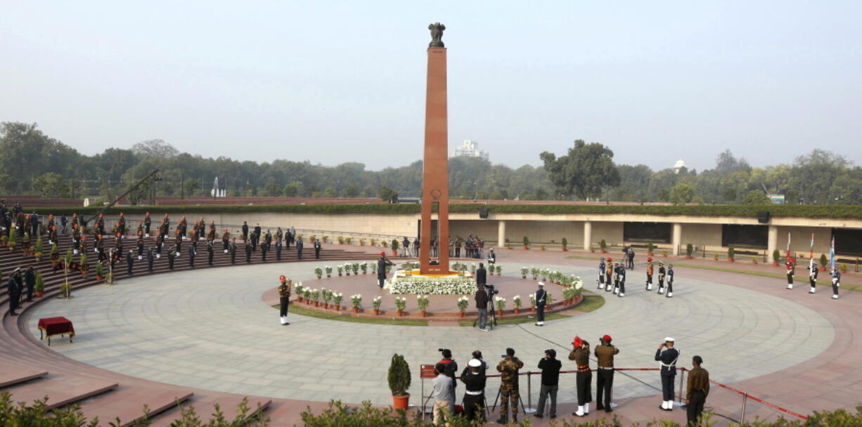 This handout photograph provided by the Indian Army shows a flame being lit at the war memorial in New Delhi, India, Friday, Jan. 21, 2022. Indian Prime Minister Narendra Modi's government came under fire from the opposition on Friday for shifting "an eternal flame" honoring Indian soldiers killed in the 1971 war with Pakistan to a new National War Memorial he inaugurated nearly three years ago. Rahul Gandhi, a top Congress party leader, accused the government of "removing history" by extinguishing the flame at the India Gate. The flame was lit by his grandmother and then Prime Minister Indira Gandhi in 1972.