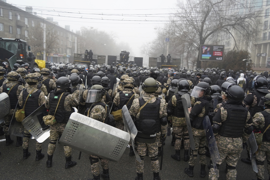 Riot police block a street to prevent demonstrators during a protest in Almaty, Kazakhstan, Wednesday, Jan. 5, 2022. Demonstrators denouncing the doubling of prices for liquefied gas have clashed with police in Kazakhstan's largest city and held protests in about a dozen other cities in the country.