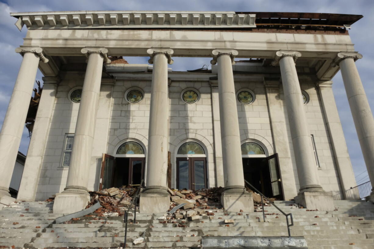 The damaged facade of the First United Methodist Church is seen on Jan. 9, 2022, in Mayfield, Ky. The century-old church has long been an anchor in the Kentucky town of about 10,000 residents, holding countless worship services, weddings, funerals and baptisms. That was before a deadly tornado swept through Mayfield in December, tearing off the church's roof and leaving rubble strewn across the entrance.