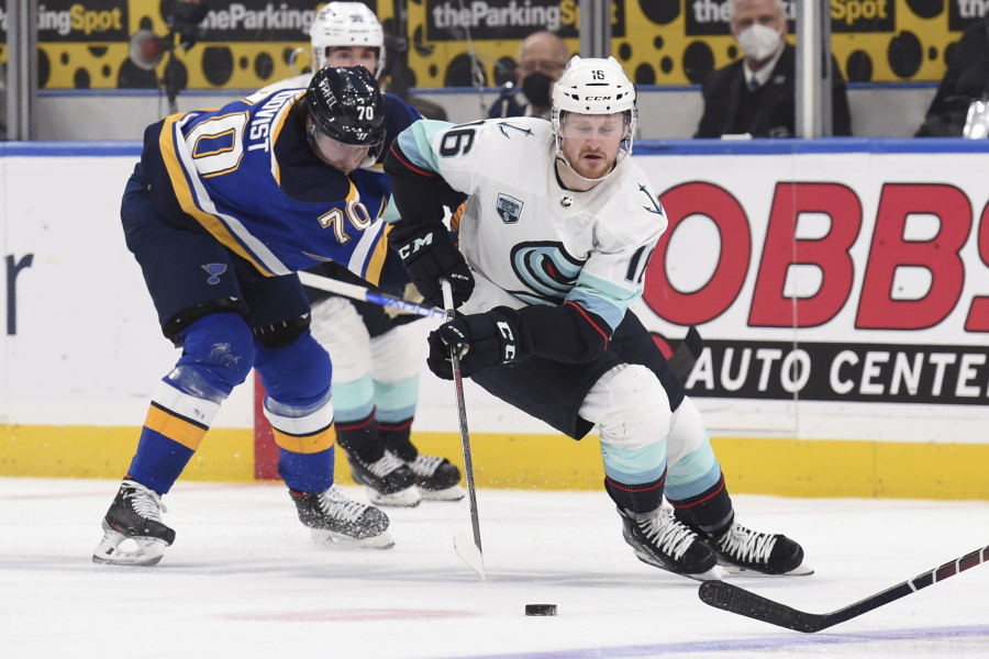 St. Louis Blues center Oskar Sundqvist (70) pressures Seattle Kraken left wing Jared McCann (16) during the third period of an NHL hockey game Thursday, Jan. 13, 2022, in St. Louis.