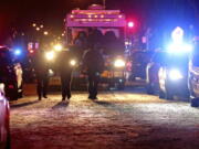 Police investigate the scene where five people were found dead in a Milwaukee, Wisc., home, Sunday, Jan. 23, 2022, in what police are investigating as multiple homicides, authorities said.