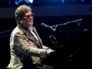FILE - Elton John performs during his "Farewell Yellow Brick Road" tour on Wednesday, Jan. 19, 2022, in New Orleans.  Despite being vaccinated and boosted, John has contracted COVID-19 and is postponing two farewell concert dates in Dallas.  John "is experiencing only mild symptoms," according to a statement.