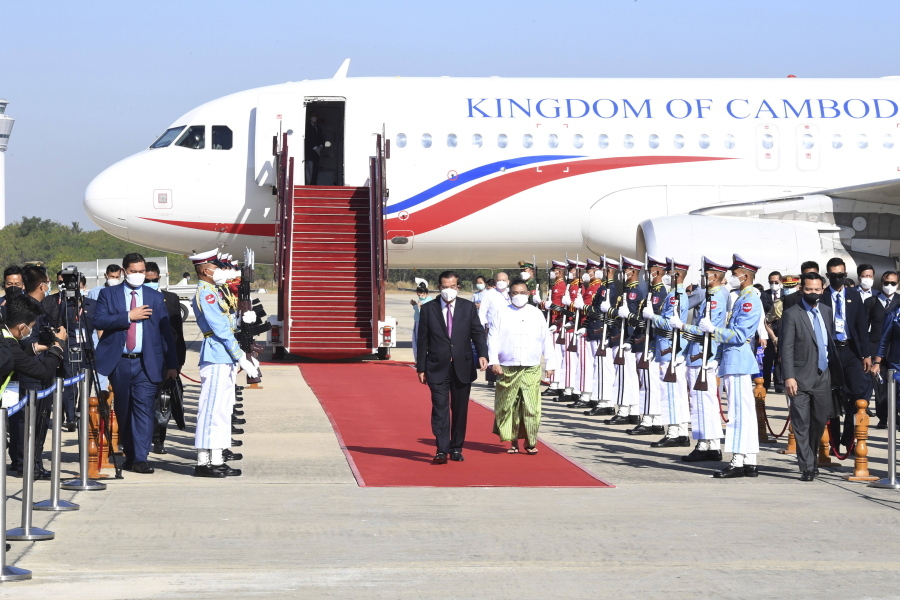 In this photo provided by An Khoun Sam Aun/National Television of Cambodia, Cambodian Prime Minister Hun Sen, center left, reviews an honor guard with Myanmar Foreign Minister Wunna Maung Lwin, center right, on his arrival at Naypyitaw International Airport in Naypyitaw, Myanmar, Friday, Jan 7, 2022.