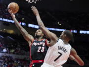 Portland Trail Blazers guard Ben McLemore, left, shoots over Brooklyn Nets forward Kevin Durant during the first half of an NBA basketball game in Portland, Ore., Monday, Jan. 10, 2022.