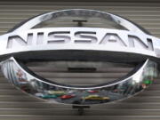 FILE - In this Wednesday, Feb. 8, 2012, file photo,  the logo of the Nissan Motors Co. is shown a showroom in Tokyo's Ginza shopping district. Nissan is recalling more than 793,000 small SUVs in the U.S. and Canada, Wednesday, Jan. 26, 2022,  because water can get into wiring and in rare cases could start a fire. The recall covers Nissan Rogue SUVs from the 2014 through 2016 model years.
