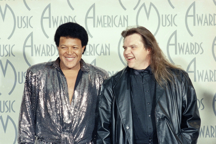 FILE - Singers Chubby Checker, left, and Meat Loaf pose for a photograph at the American Music Awards in Los Angeles, Jan. 26, 1987. Meat Loaf, the rock superstar loved by millions for his '??Bat Out of Hell'?? album and for such theatrical, dark-hearted anthems as '??Paradise by the Dashboard Light'?? and '??Two Out of Three Ain'??t Bad,'?? has died at age 74. A family statement on his official Facebook page says the singer born Marvin Lee Aday died Thursday night, Jan. 20, 2022. '??Bat Out of a Hell,'?? his mega-selling collaboration with songwriter Jim Steinman, came out in 1977 and became one of the bestselling records in history. (AP Photo/Lennox McLendon, File) (G.