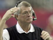 FILE - Atlanta Falcons coach Dan Reeves adjusts his headset at the start of play against the Detroit Lions at the Georgia Dome in Atlanta Sunday, Dec. 22, 2002.  Reeves, who won a Super Bowl as a player with the Dallas Cowboys but was best known for a long coaching career highlighted by four more appearances in the title game with the Denver Broncos and Atlanta Falcons, died Saturday, Jan. 1, 2022.