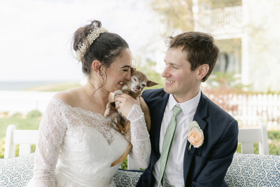 Caitlin Koska, left, and Michael White play with their 14-year-old rescue dog, Luna, at their wedding May 1 in St. Joseph, Mich. The couple adopted their pet after her owner died through Tyson's Place Animal Rescue, a specialized organization focused on helping the terminally ill and seniors headed to residential care.