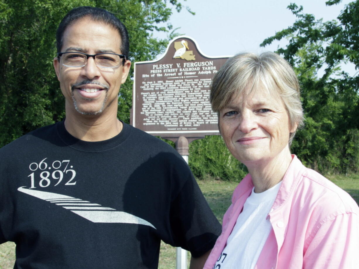 FILE - Keith Plessy and Phoebe Ferguson, descendants of the principals in the Plessy V. Ferguson court case, pose for a photograph in front of a historical marker in New Orleans, on Tuesday, June 7, 2011.  Homer Plessy, the namesake of the U.S. Supreme Court's 1896 "separate but equal" ruling, is being considered for a posthumous pardon. The Creole man of color died with a conviction still on his record for refusing to leave a whites-only train car in New Orleans in 1892.