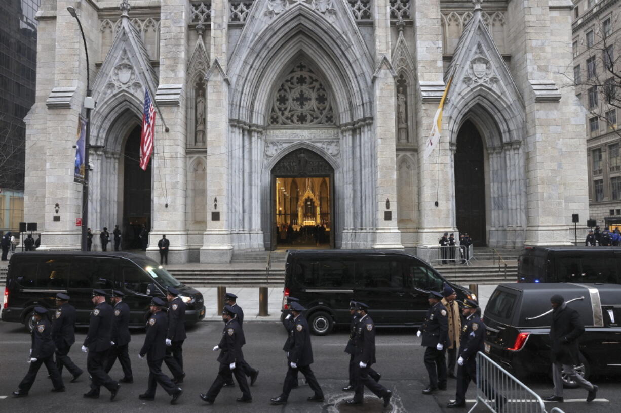 New York Police officers gather for the funeral of Officer Jason Rivera, Friday, Jan. 28, 2022, outside St. Patrick's Cathedral in New York. Rivera and his partner, Officer Wilbert Mora, were fatally wounded when a gunman ambushed them in an apartment as they responded to a family dispute last week.