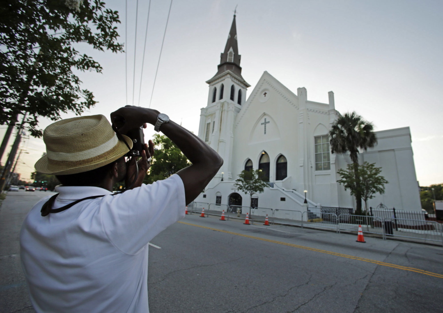 FILE -- This file photo shows Ausar Vandross taking a photo of Mother Emanuel AME Church in Charleston, S.C., on Thursday, June 16, 2016. The church is among those that have been assisted by a fund to help historic Black churches, and a new, $20 million donation will help additional ones.