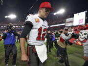 Tampa Bay Buccaneers quarterback Tom Brady (12) reacts as he leaves the field after the team lost to the Los Angeles Rams during an NFL divisional round playoff football game Sunday, Jan. 23, 2022, in Tampa, Fla.