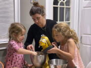 Danielle McWilliams cooks with her daughters Reese, 7, right, and Remi, 4, at their New Jersey home. Along with the usual cupcakes, crispy treats and from-scratch cookies, they make tarallis, an Italian traditional treat.