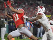 Ohio State wide receiver Jaxon Smith-Njigba, left, catches a touchdown next to Utah cornerback Malone Mataele during the second half in the Rose Bowl NCAA college football game Saturday, Jan. 1, 2022, in Pasadena, Calif.