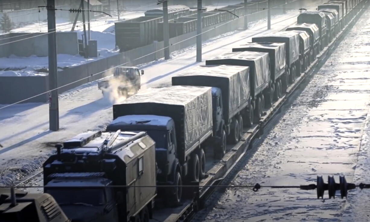In this photo taken from video provided by the Russian Defense Ministry Press Service, Russian military vehicles on a railway platform on their way to attend a joint military drills in Belarus, in Russia, Monday, Jan. 24, 2022. Russia has sent an unspecified number of troops from the country's far east to its ally Belarus, which shares a border with Ukraine, for major war games next month.