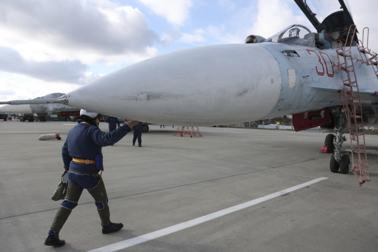 A Russian air force pilot walks to aSu-30 fighter jet before a training mission in Krasnodar Region, Russia, Wednesday, Jan. 19, 2022.