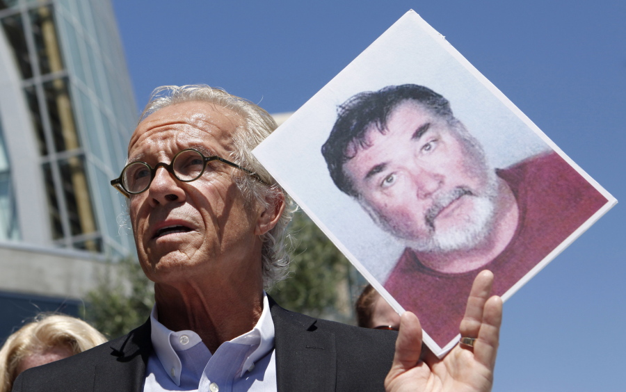 FILE - Attorney Jeff Anderson holds up a photo of former priest Stephen Kiesle at a news conference in Oakland, Calif., Wednesday, Aug. 18, 2010. The family of the late Jim Bartko, who said he was molested as a child by Kiesle, has filed a lawsuit against the Roman Catholic church under a new California law that allows family members of sex abuse victims to bring lawsuits after their deaths. The family of Bartko filed the suit in January 2022 in Alameda County Superior Court against the Diocese of Oakland.