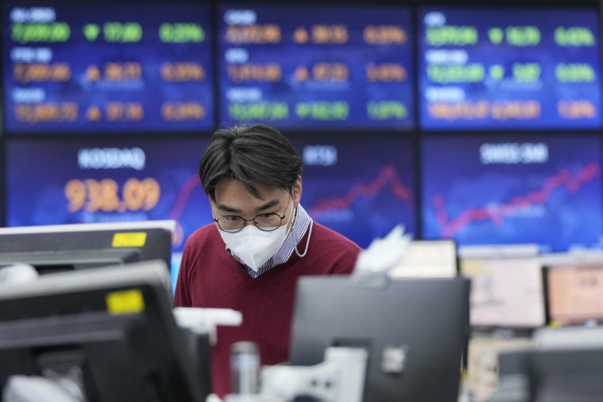 A currency trader watches monitors at the foreign exchange dealing room of the KEB Hana Bank headquarters in Seoul, South Korea, Thursday, Jan. 20, 2022. Asian stock markets rose Thursday after China cut interest rates to shore up flagging economic growth and Japan reported a double-digit rise in exports.