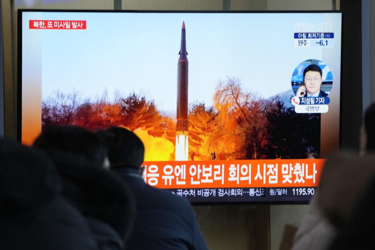 People watch a TV showing a file image of North Korea's missile launch during a news program at the Seoul Railway Station in Seoul, South Korea, Tuesday, Jan. 11, 2022. North Korea on Tuesday fired what appeared to be a ballistic missile into its eastern sea, its second weapons launch in a week, the militaries of South Korea and Japan said.