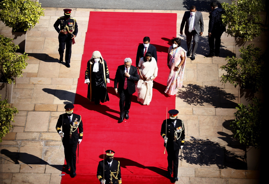Sri Lankan President Gotabaya Rajapaksa, center, arrives for a new session of Parliament in Colombo, Sri Lanka, Tuesday, Jan. 18, 2022. Rajapaksa on Tuesday promised human rights reforms and "justice" for missing persons from the country's civil war, after years of resisting calls for such measures.