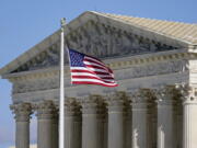 FILE - An American flag waves in front of the Supreme Court building on Capitol Hill in Washington, Nov. 2, 2020.