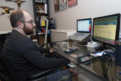 Ethan Miller works on his taxes at home in Silver Spring, Md., Friday, Jan., 21, 2022.