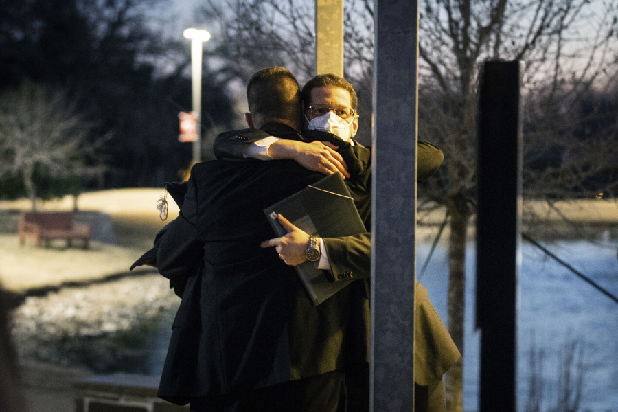 Congregation Beth Israel Rabbi Charlie Cytron-Walker, facing camera, hugs a man after a healing service Monday night, Jan. 17, 2022, at White's Chapel United Methodist Church in Southlake, Texas. Cytron-Walker was one of four people held hostage by a gunman at his Colleyville, Texas, synagogue on Saturday.
