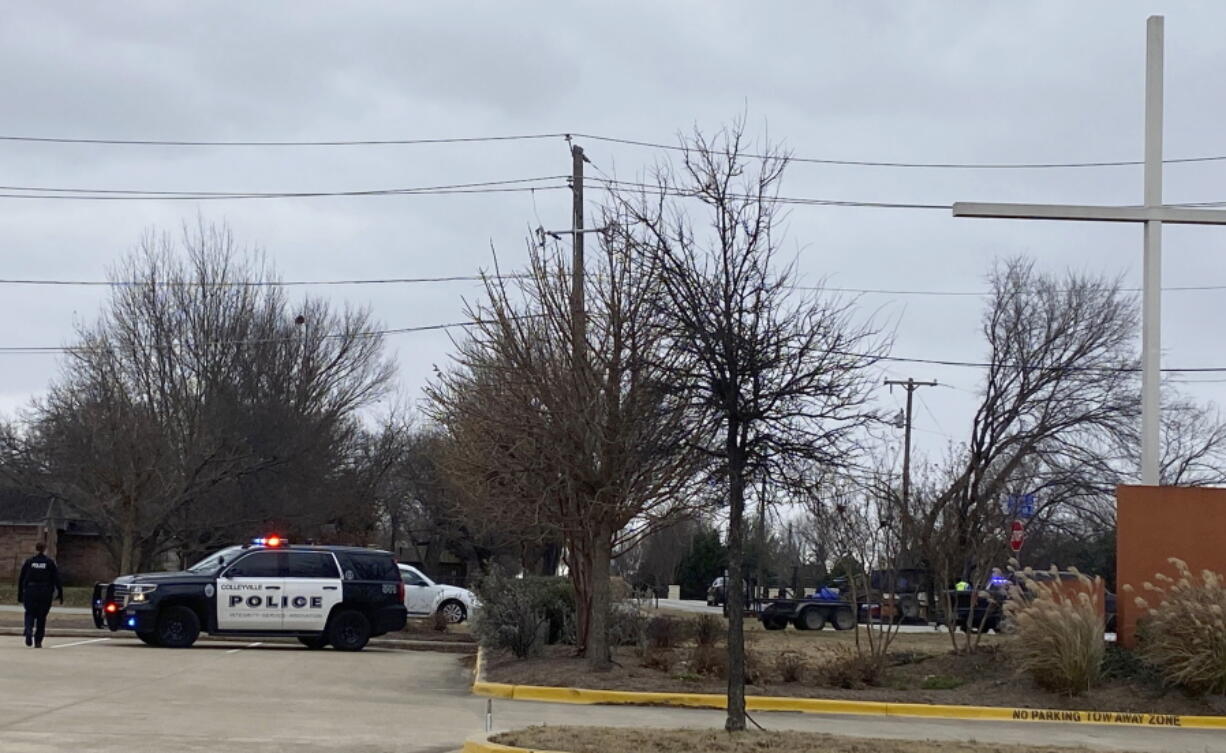 Colleyville police secure the area around Congregation Beth Israel synagogue on Saturday, Jan. 15, 2022 in Colleyville, Texas.   Authorities say a man has apparently taken hostages at the synagogue near Fort Worth, Texas.