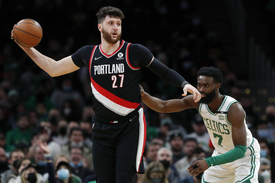 Portland Trail Blazers' Jusuf Nurkic (27) keeps the ball away from Boston Celtics' Jaylen Brown (7) during the first half of an NBA basketball game Friday, Jan. 21, 2022, in Boston.