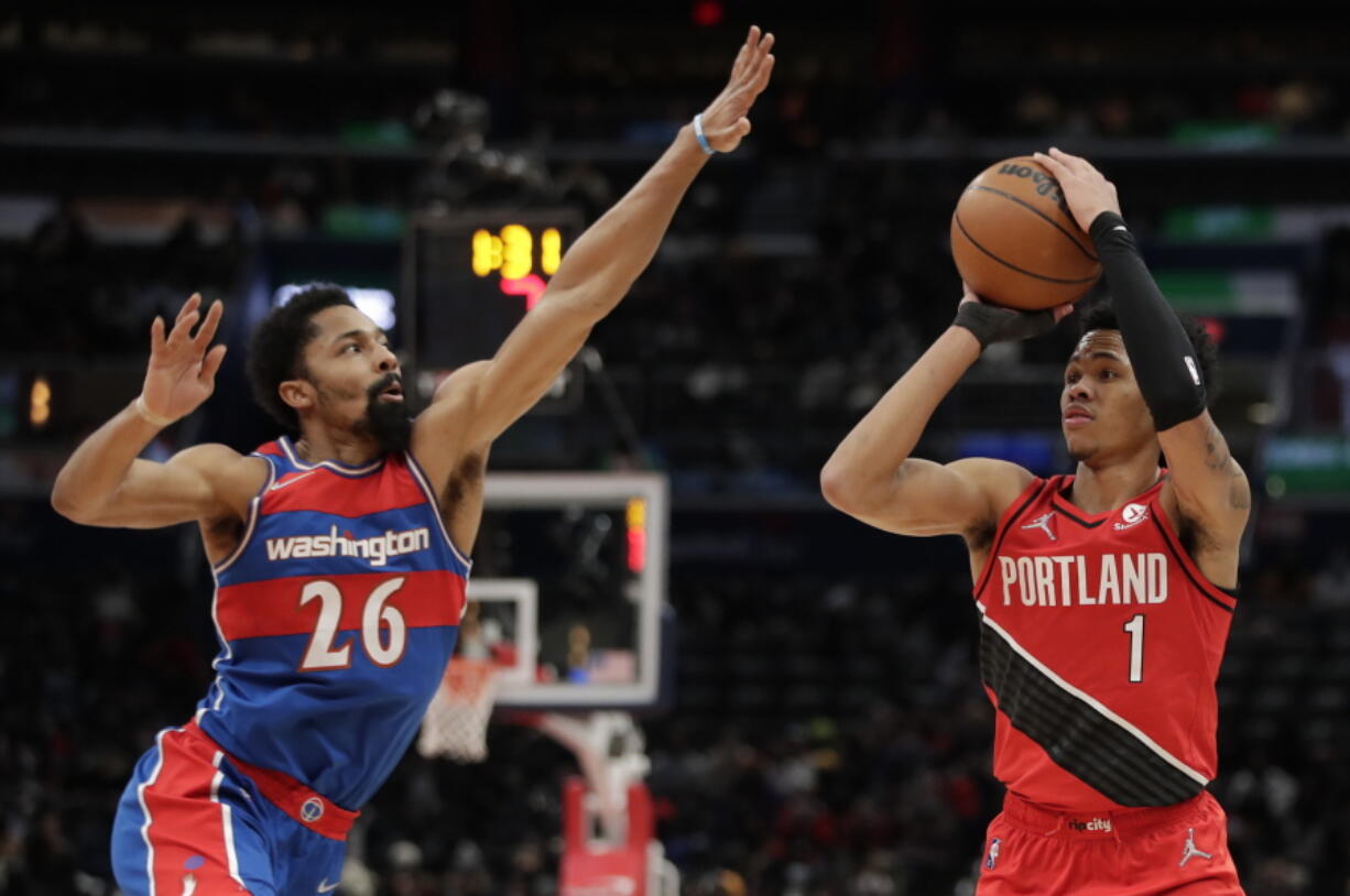Portland Trail Blazers' Anfernee Simons (1) shoots as Washington Wizards' Spencer Dinwiddie (26) defends during the second half of an NBA basketball game, Saturday, Jan. 15, 2022, in Washington. (AP Photo/Luis M.
