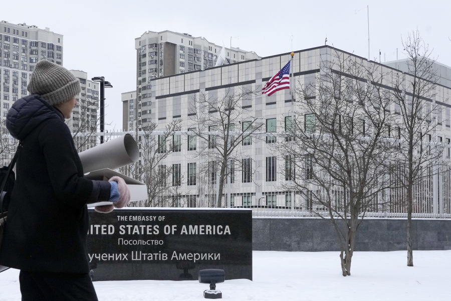 A woman walks past the U.S. Embassy in Kyiv, Ukraine, Monday, Jan. 24, 2022. The State Department is ordering the families of all American personnel at the U.S. Embassy in Kyiv to leave the country and allowing non-essential staff to leave Ukraine. The move comes amid heightened fears of a Russian invasion of Ukraine despite talks between U.S. and Russian officials.