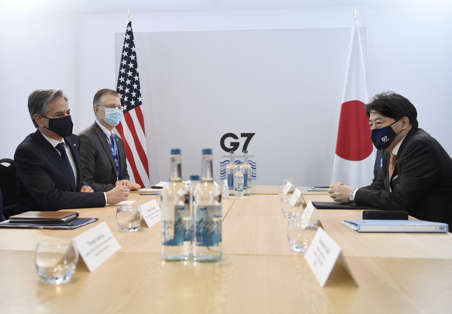 FILE - Secretary of State Antony Blinken, left, and Japan's Foreign Minister Yoshimasa Hayashi, right, pose for a photo before holding a bilateral meeting in Liverpool, England, Dec. 11, 2021. Top U.S. and Japanese officials are holding strategic and security talks on Thursday, Jan. 6, 2022, just two weeks after negotiators ended a Trump-era row by agreeing in principal to a new formula for paying for the American military presence in Japan.