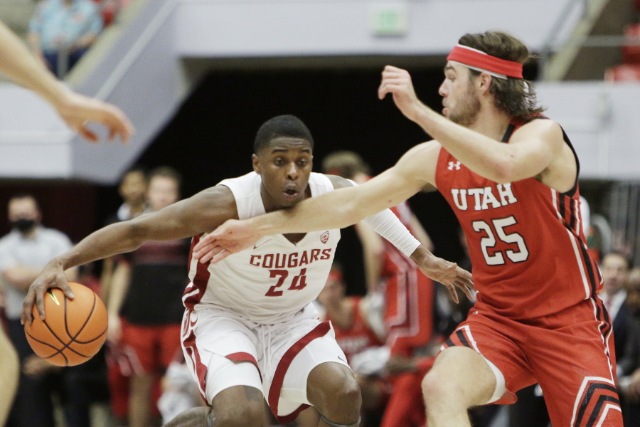 Washington State guard Noah Williams (24) drives the ball while pressured by Utah guard Rollie Worster (25) during the second half of an NCAA college basketball game, Wednesday, Jan. 26, 2022, in Pullman, Wash. Washington State won 71-54.