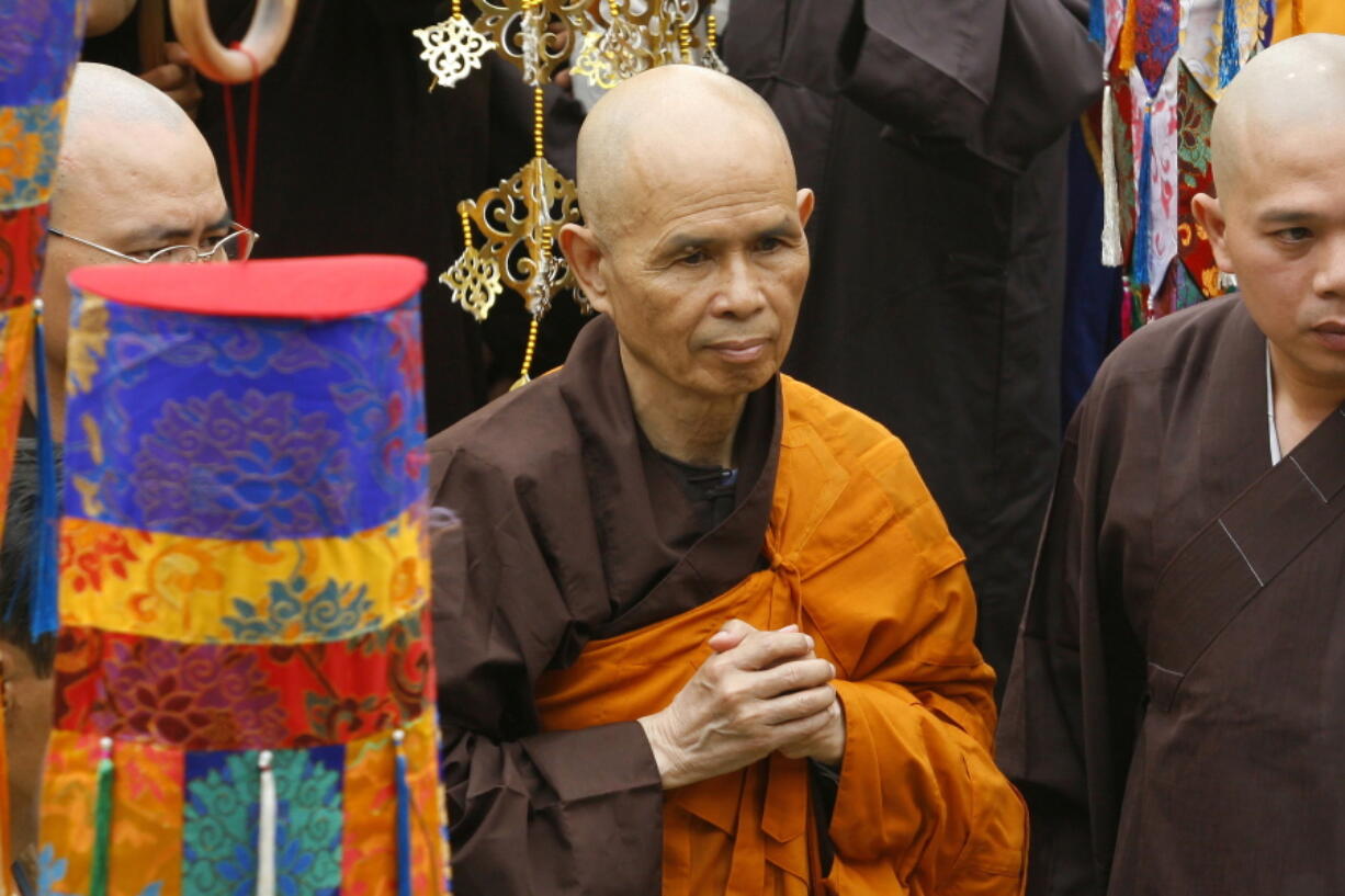 FILE - Vietnamese Zen master Thich Nhat Hanh, center, arrives for a great chanting ceremony at Vinh Nghiem Pagoda in Ho Chi Minh City, Vietnam on March 16, 2007. Zen Buddhist monk Thich Nhat Hanh, who helped pioneer the concept of mindfulness in the West and socially engaged Buddhism in the East, has died at age 95 on Saturday, Jan. 22, 2022, according to an announcement on his verified Twitter page.