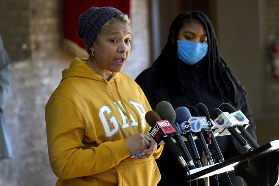 Cheri Warner, left, stands with her daughter, Brea, and speaks calling for the Chicago school district and teacher's union to focus on getting students back in the classroom Monday, Jan. 10, 2022, in Chicago. Hundreds of thousands of Chicago students remained out of school for a fourth day Monday, after leaders of the nation's third-largest school district failed to resolve a deepening clash with the influential teachers union over COVID-19 safety protocols.