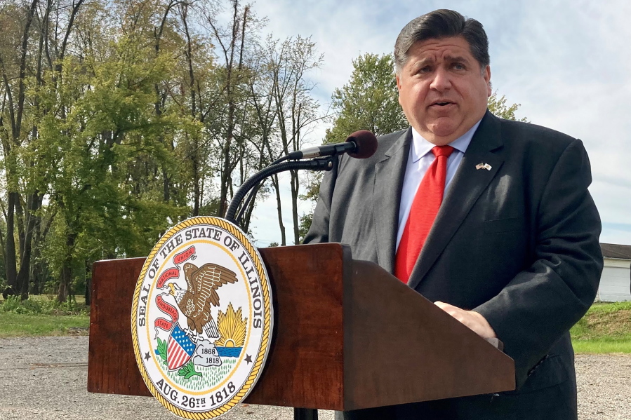 FILE - Illinois Gov. J.B. Pritzker announces a new round of COVID-19-related emergency housing assistance, on Oct. 27, 2021, at Abundant Faith Christian Center in Springfield, Ill. Democrats are speaking out against school closures even as the omicron surge puts additional pressures on public schools.