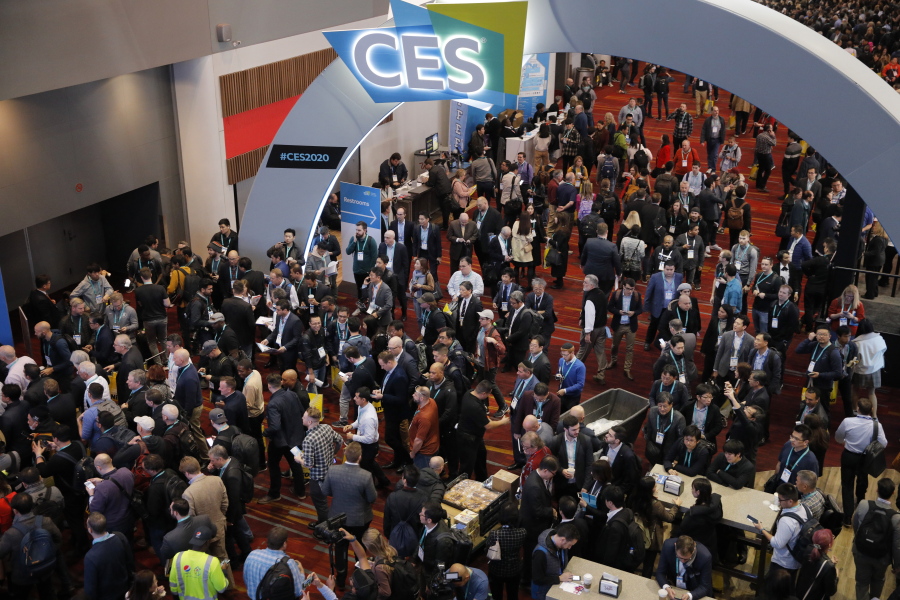 FILE - Crowds enter the convention center on the first day of the CES tech show, on,Jan. 7, 2020, in Las Vegas. The annual CES gadget convention will be three days instead of four following an uptick of COVID-19 cases and the withdrawal of some of its best-known tech presenters.