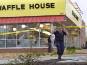 FILE - In this April 22, 2018, file photo, law enforcement officials work the scene of a fatal shooting at a Waffle House in the Antioch neighborhood of Nashville, Tenn. Jury selection is set to begin on Tuesday, Jan. 25, 2022, in the murder trial of a man who killed four people at a Nashville Waffle House in April 2018 and led police on a two-day manhunt.