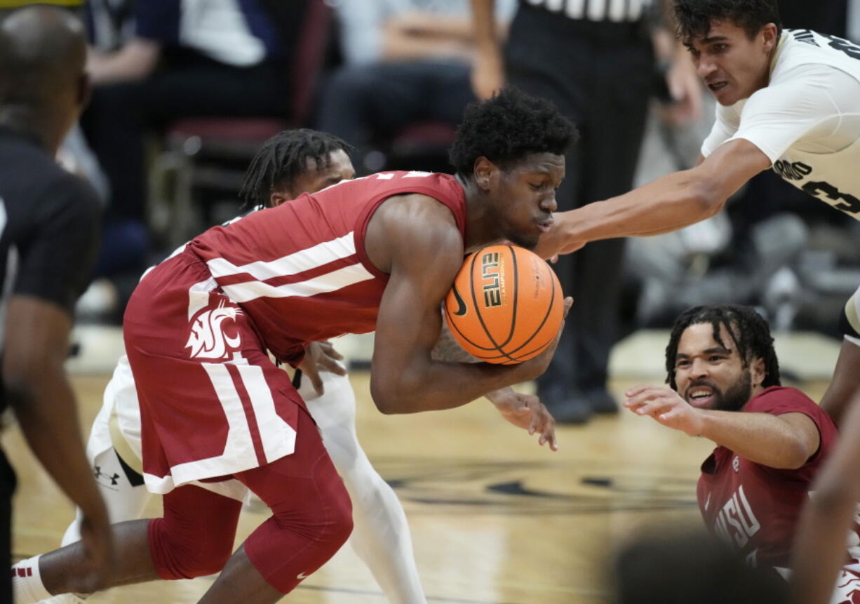 Washington State guard T.J. Bamba, front left, recovers the ball as Colorado guard Keeshawn Barthelemy, back left, and Colorado forward Tristan da Silva, front right, defend while Washington State guard Michael Flowers looks on in the second half of an NCAA college basketball game Thursday, Jan. 6, 2022, in Boulder, Colo.