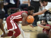 Washington State guard T.J. Bamba, front left, recovers the ball as Colorado guard Keeshawn Barthelemy, back left, and Colorado forward Tristan da Silva, front right, defend while Washington State guard Michael Flowers looks on in the second half of an NCAA college basketball game Thursday, Jan. 6, 2022, in Boulder, Colo.