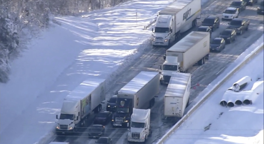 Motorists sit stranded on Interstate 95 in Northern, Va., on Tuesday, Jan. 4, 2022. Hundreds of motorists were stranded all night in snow and freezing temperatures along a 50-mile stretch of Interstate 95 after a crash involving six tractor-trailers in Virginia, where authorities were struggling Tuesday to reach them.
