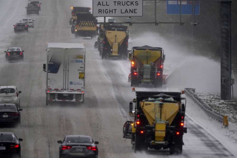 Vehicles navigate hazardous driving conditions along Interstate 85/40 as a winter storm moves through the area in Mebane, N.C., Sunday, Jan. 16, 2022.