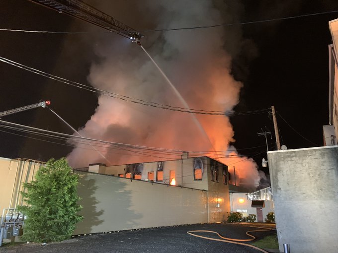 Fire personnel battle a blaze in Hillsboro, Ore., that damaged as many as 20 businesses.