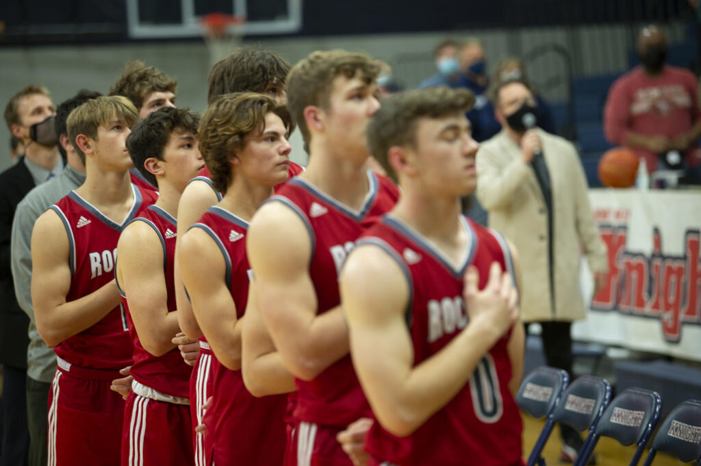 Castle Rock players stand for the national anthem prior to their game at King's Way Christian on Tuesday, Jan.