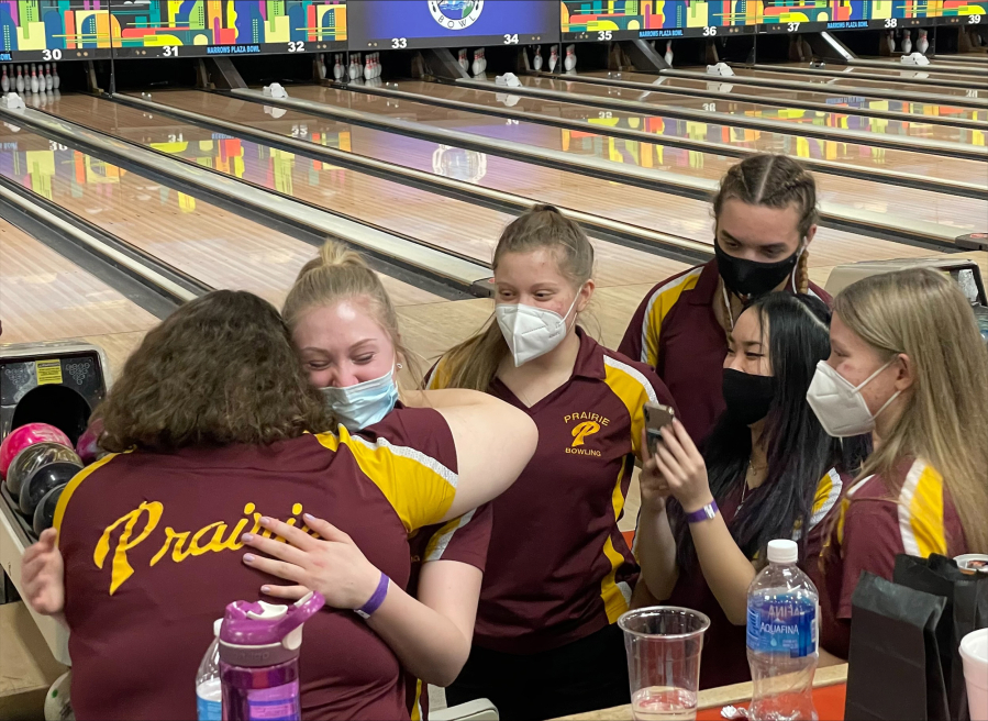 Evergreen coach Robin Bailey, right, talks to her team before the start of a game Thursday at Narrows Plaza Bowl in University Place.