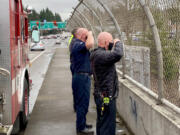 Clark County Fire District 6 personnel pay their respects Thursday to slain Vancouver police Officer Donald Sahota as his body was transported from Vancouver to Battle Ground, along Interstate 5.
