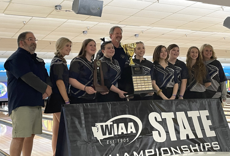 Skyview bowlers and coaches pose for photos with the first-place trophy after winning the Class 4A state championship on Saturday at Narrows Plaza Bowl in University Place.