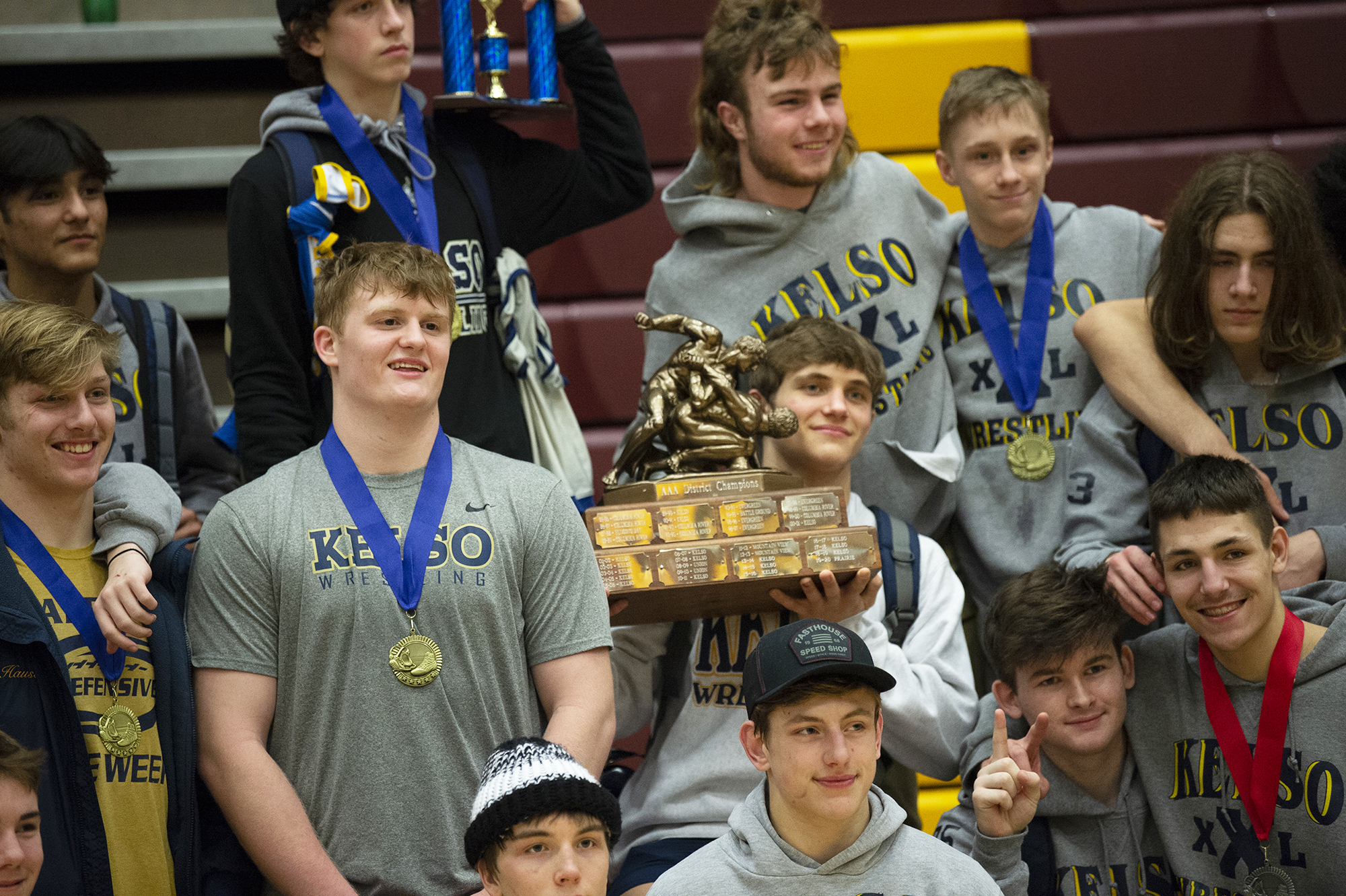 Ethan Freund holds the championship trophy after Kelso won the team title at the 3A district wrestling tournament at Prairie High School on Feb. 5, 2022.