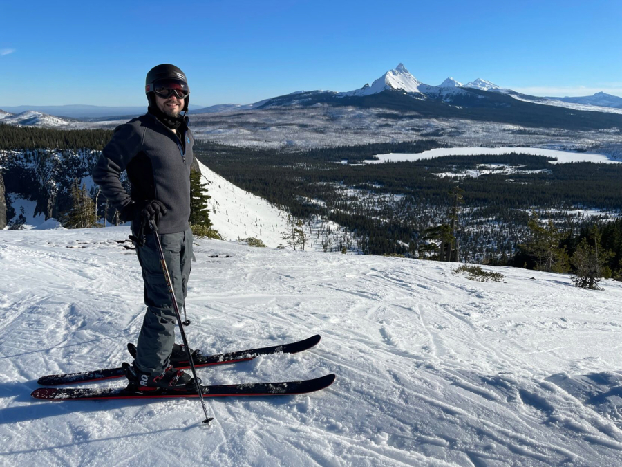 Tony Barnes, of Vancouver, gets ready to ski from the top of Hoodoo with Mount Washington and the Three Sisters in the background on Jan. 16.